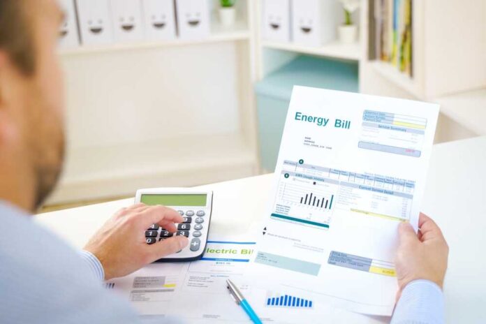 Man,Calculating,Electric,Bill,Statement,And,Home,Energy,Consumption