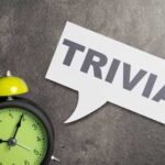 Green alarm clock next to a speech bubble with the word 'TRIVIA'