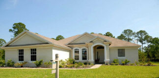 Large house with a for sale sign