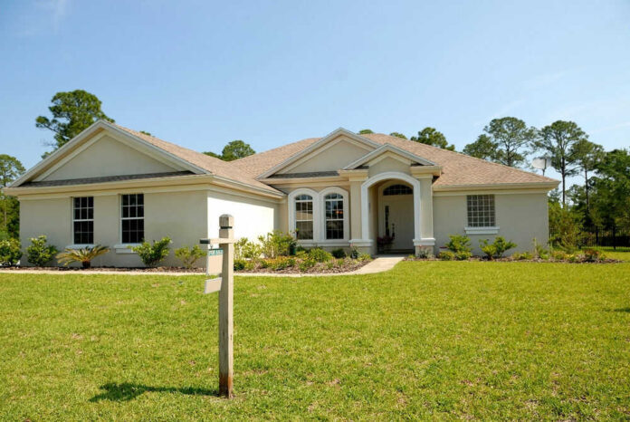 77705143 Large house with a for sale sign
